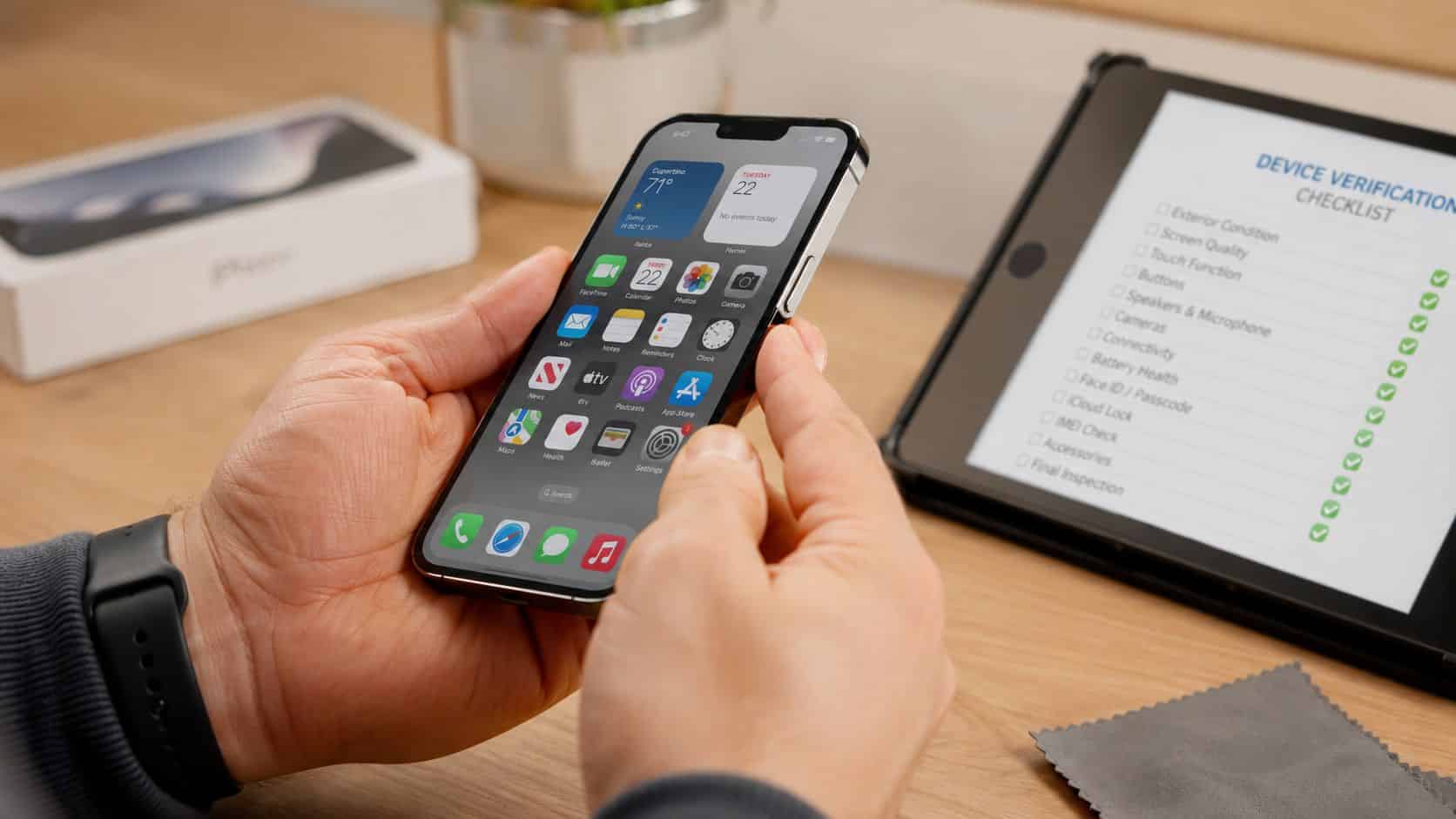 Understanding What Does Refurbished Mean Iphone: A 2026 3 A technician checking a refurbished iPhone using a digital verification checklist on a tablet device.