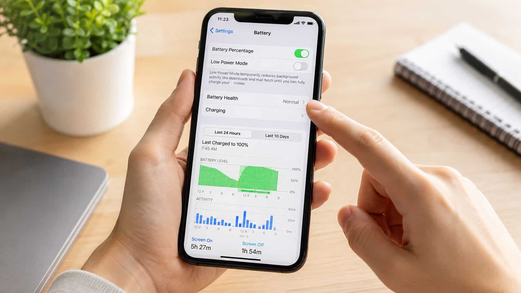 Refurbished iPhone Battery Health UK: Your 2026 Guide 1 A person holding an iPhone displaying the battery settings menu showing usage statistics and health status.