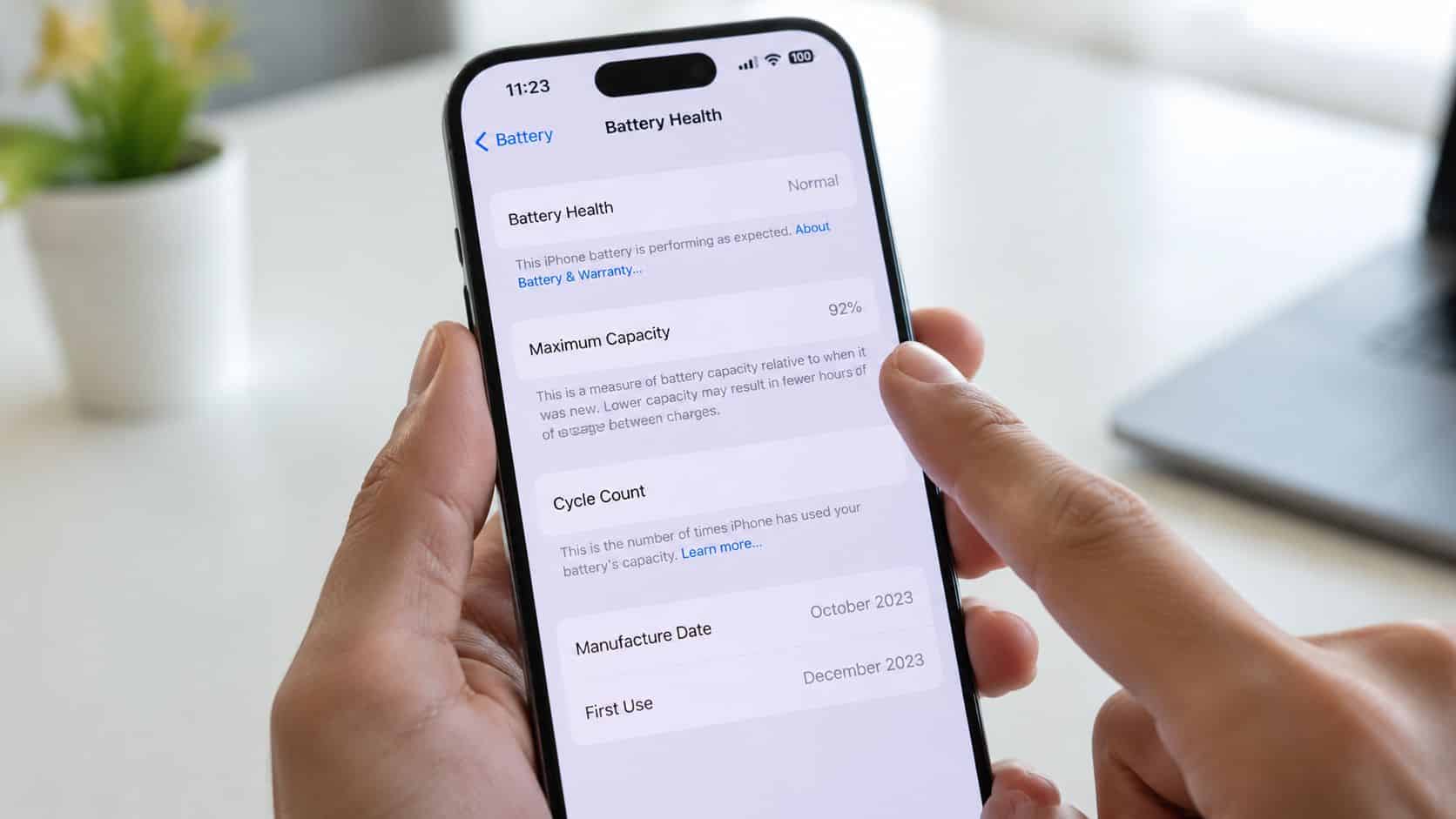Your Refurbished iPhone Battery Replacement UK Guide 2026 1 A person holding an iPhone displaying the battery health settings screen showing ninety-two percent maximum capacity.