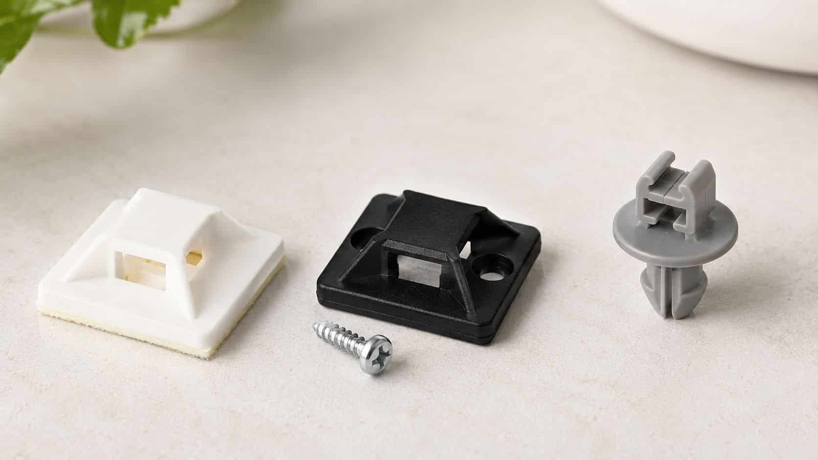 Cable Ties Mounts: A Practical Guide for Tidy Cables 1 A white adhesive cable tie mount, a black screw-in mount with a screw, and a grey push-mount clip.
