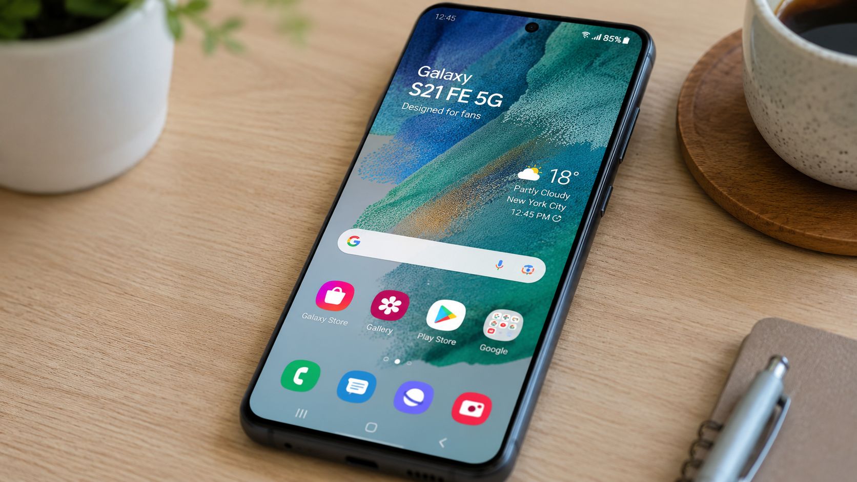 Samsung Galaxy S21 FE 5G: Refurb Buying Guide 2 A Samsung Galaxy S21 FE 5G smartphone placed on a wooden desk next to a coffee mug.
